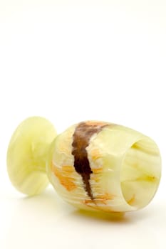 A glass of semi-precious stone onyx with healing and protective forces, according to beliefs. Selective focus with shallow depth of field.
