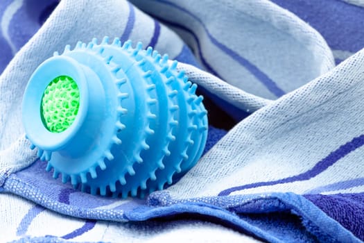 Silicone ball dryer removes moss from clothes and prevents creasing of clothes when drying. Selective focus with shallow depth of field.