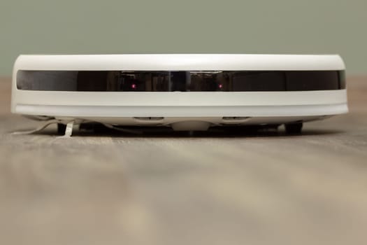 Modern digital home robot vacuum cleaner. Selective focus with shallow depth of field.