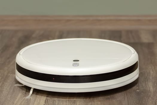 Modern digital home robot vacuum cleaner. Selective focus with shallow depth of field.
