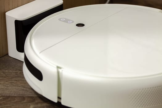 Modern digital home robot vacuum cleaner. Selective focus with shallow depth of field.