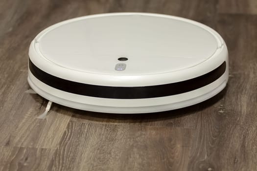 Modern digital home robot vacuum cleaner. Selective focus with shallow depth of field.