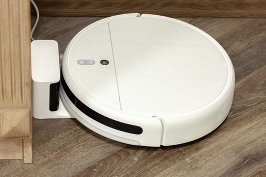 Modern digital home robot vacuum cleaner. Selective focus with shallow depth of field.
