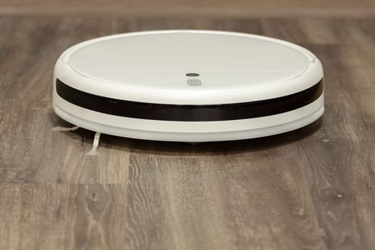 Modern digital home robot vacuum cleaner. Selective focus with shallow depth of field.