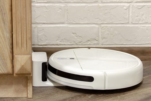 Modern digital home robot vacuum cleaner. Selective focus with shallow depth of field.