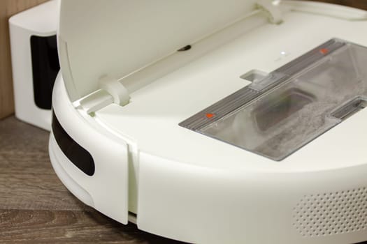 Modern digital home robot vacuum cleaner. Selective focus with shallow depth of field.
