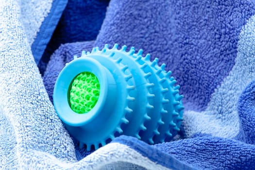 Silicone ball dryer removes moss from clothes and prevents creasing of clothes when drying. Selective focus with shallow depth of field.