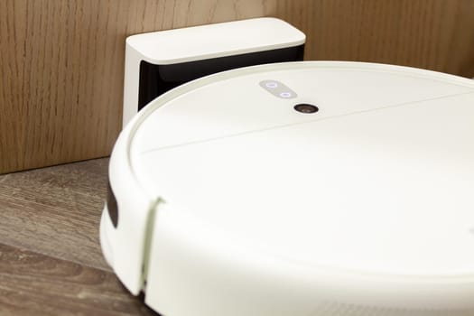 Modern digital home robot vacuum cleaner. Selective focus with shallow depth of field.