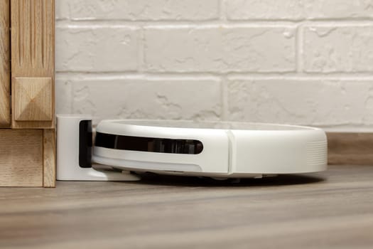 Modern digital home robot vacuum cleaner. Selective focus with shallow depth of field.