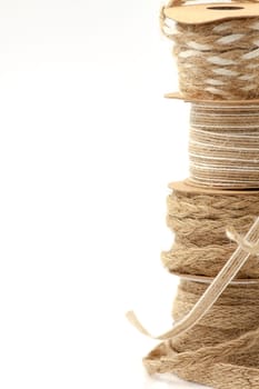 Rolls of braided cord of sackcloth and hemp for decoration and decoration. Selective focus with shallow depth of field.