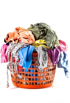 Red plastic laundry basket full of colorful clothes