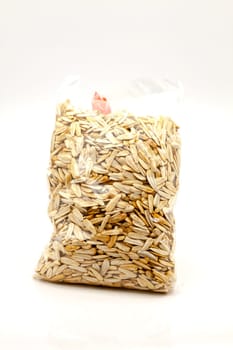 Seeds of large white roasted sunflower, packed in a transparent plastic bag. Selective focus with shallow depth of field.