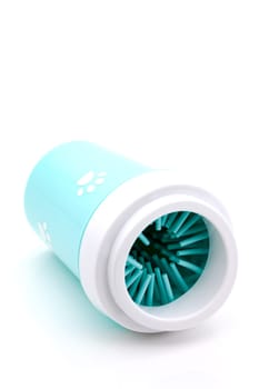 A mug for cleaning the pet's paws with a gentle soft silicone brush on the inside, filled with soap and water.