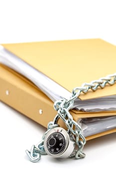 Cardboard document folders locked with chain and padlock. Selective focus with shallow depth of field.