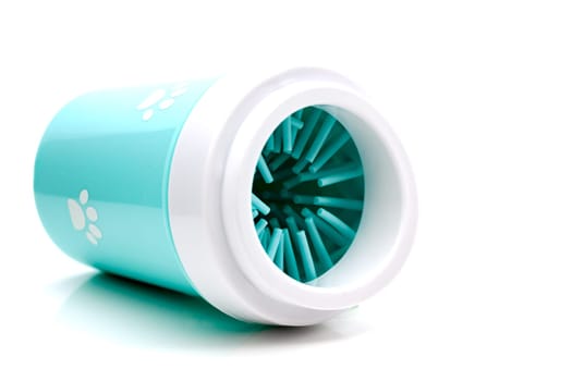 A mug for cleaning the pet's paws with a gentle soft silicone brush on the inside, filled with soap and water.