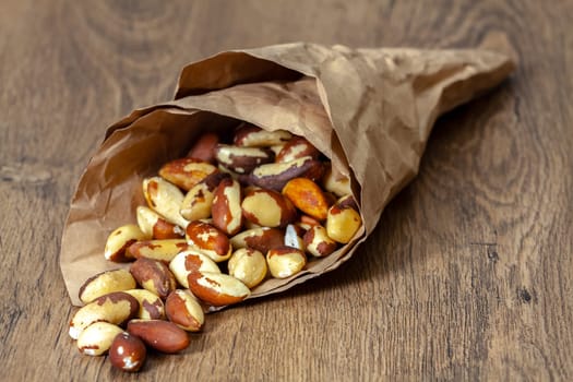 Brazilian walnut in crumpled paper purse. Selective focus with shallow depth of field.