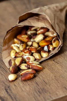 Brazilian walnut in crumpled paper purse. Selective focus with shallow depth of field.