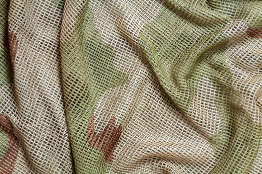 Close up of a military, tactical mesh camouflage scarf.