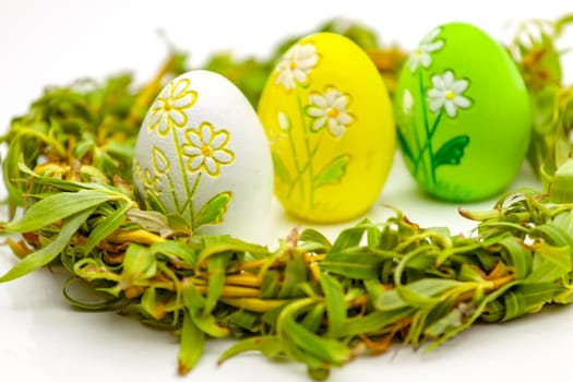 Traditionally painted red Easter egg and willow twig. Selective focus with shallow depth of field.