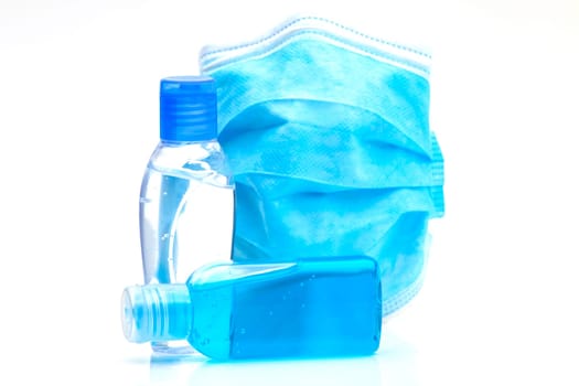 Bottles with antibacterial disinfectant and disposable mask. Selective focus with shallow depth of field.