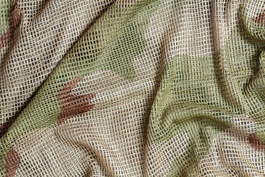 Close up of a military, tactical mesh camouflage scarf.