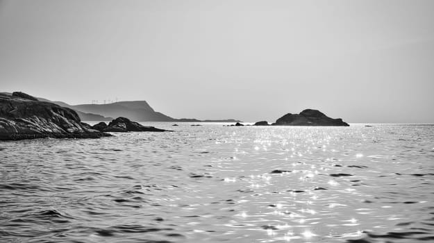 Norwegian fjord landscape. View of the open sea at the Western Cape in black and white. Crystal clear water, glistening in the sunshine. Landscape from Scandinavia