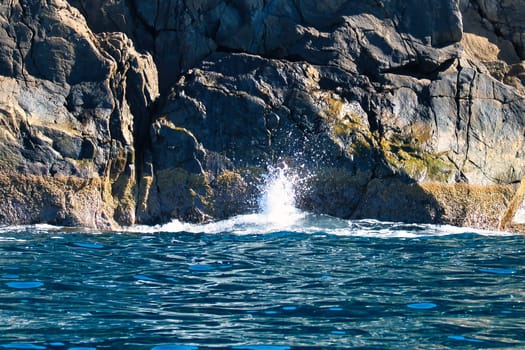 Norwegian fjord landscape. Waves crash against rocks. Water splashes against the rocks. Landscape in Scandinavia