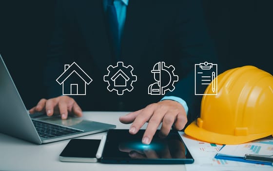 Architect or engineer using tablet to work on table, Cost calculation, construction planning, Structural calculation, Construction cost planning, structural design, Project presentation plan.