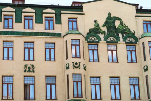 Many windows and the green relief called "Glorification of Russia"", a depiction of the Roman god Neptune on the facade of the Hotel Moskva, Palace Rossiya, an example of Art Nouveau architecture in the city center of Belgrade, Serbia 2022"