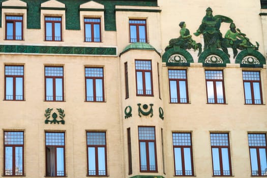 Many windows and the green relief called "Glorification of Russia"", a depiction of the Roman god Neptune on the facade of the Hotel Moskva, Palace Rossiya, a famous Art Nouveau building in the city center of Belgrade, Serbia 2022"