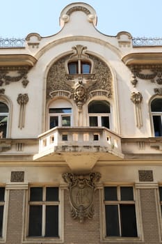 The balcony on the elaborate facade of the Aron Levi Trading house, surrounded by ornaments and reliefs, an example of Art Nouveau architecture in the city center of Belgrade, Serbia 2022