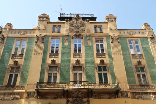 The facade of the Stamenkovic House, Building of Merchant Stamenkovic, decorated with green tiles, stucco, reliefs and detailed handrails, an example of Art Nouveau architecture in the city center of Belgrade, Serbia 2022