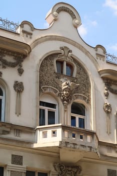 The balcony on the facade of the elaborate Aron Levi Trading house, surrounded by ornaments and reliefs, an example of Art Nouveau architecture in the city center of Belgrade, Serbia 2022