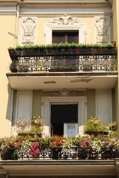 Two balconies with many plants and flowers on an old building in the city center of Belgrade, Serbia 2022