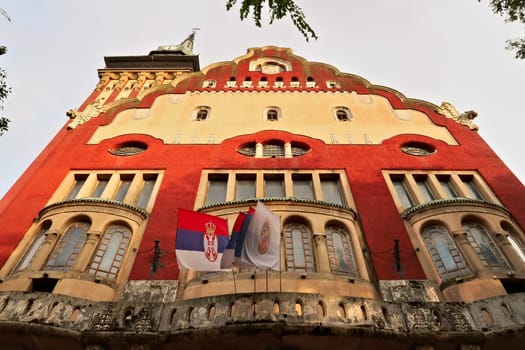 Looking up the facade and clock tower of the city hall, town hall of Subotica, an example of Art Nouveau architecture in the city center, Subotica, Serbia 2022