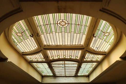 Colorful stained glass window inside the stairwell, staircase of the Menraths, Menrats Palace, an example of Art Nouvea architecture in the city center, old town of Novi Sad, Serbia 2022