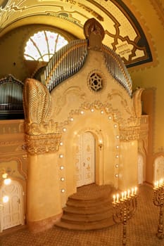 The elaborate altar inside the Synagogue of Subotica, illuminated by lights and candles, Subotica, Serbia 2022