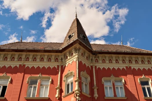 The beautiful facade of the Vojnic Palace building with a bay window, tower in the city center of Subotica, Serbia 2022