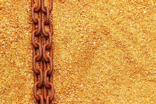 Rusty chains. Selective focus on two old big rusty ships anchor chains on the sand near the sea with large copy space. Abstract background on sand. Macro.