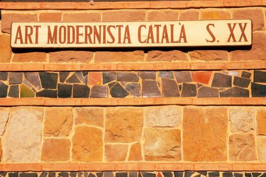 Lloret de Mar, Catalonia, Spain, 07 Oct 2019. A sign on the Sant Roma parish church in Lloret de Mar. Mosaic building of Catalan Modernism architecture. Antoni Gaudi.