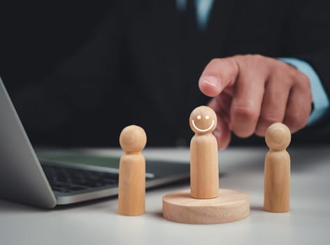 Businessmen pointing to the wooden doll, Screening employee information, Effective personnel management in the organization, Human resources management concept.