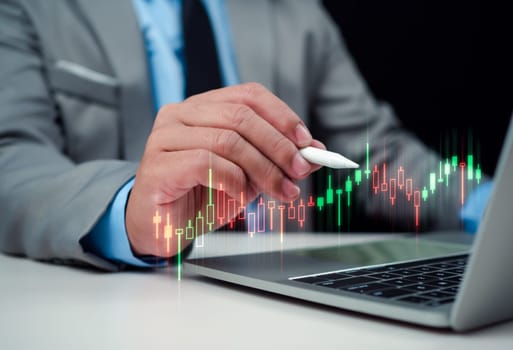 Stock market, Progress or success concept, Business growth, Businessman or trader is showing a growing virtual hologram stock on computer, Planning and strategy, Invest in trading.