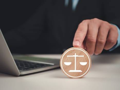 Businessman pointing at circular piece of wood with a scale mark for business legal advice, Labor law, Legal advice business concept, Lawyer icon, Lawyer background, Signing of joint ventures.