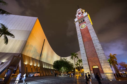 Hong Kong 06 April 2024: Tsim Sha Tsui clock tower in Hong Kong city at night
