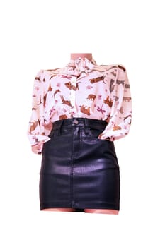 Mannequin wearing black leather skirt and trendy blouse. Female leather garment. Girl's casual outfit with stylish top. Girl`s attractive stylish look. Clipping path.