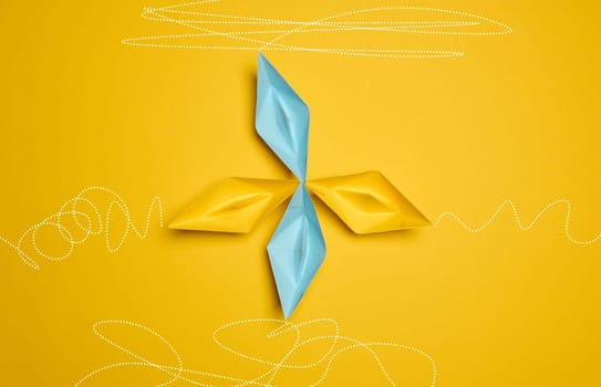 Four paper boats stand at the same departure point, but different trajectories are drawn. The concept of uniqueness, everyone has their own path
