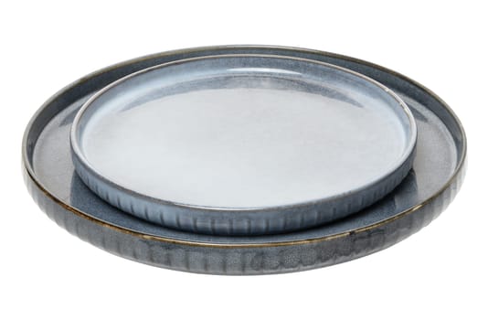 Empty blue round ceramic plate at an angle on isolated background