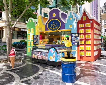 Baku, Azerbaijan - May 5, 2024: Colorful food kiosk on Nizami Street, featuring a Holland Fries sign and various food items displayed