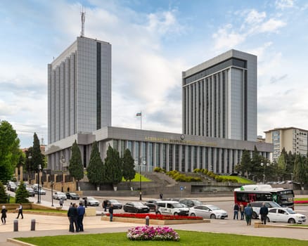 Baku, Azerbaijan - May 6, 2024: View of the National Assembly building, showcasing its Soviet Modernism Architecture and surrounding cityscape in a summer sunny day