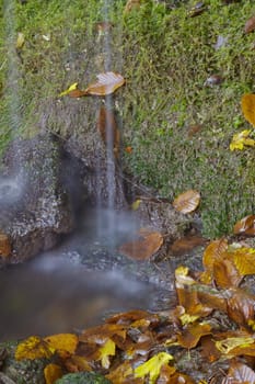 Detail of the waterway of a mountain waterfall, breathtaking.Selective focus with shallow depth of field.